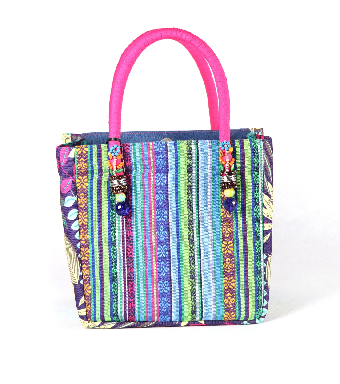 Comes in pink handle, blue denim body, floral patterns on the sides, and a colorful stripe at the back.