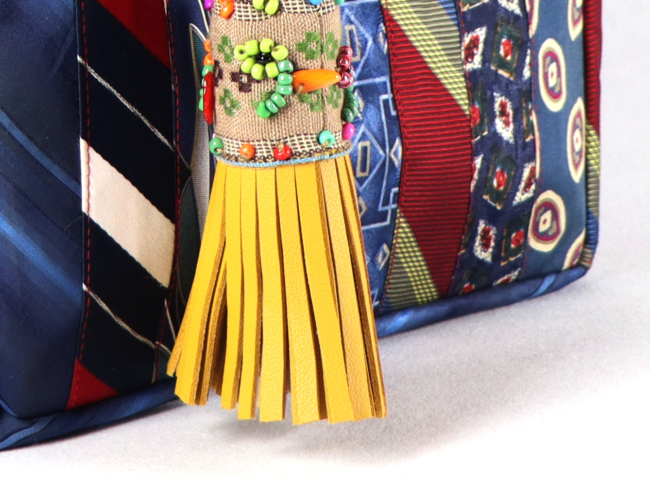 Goes in red handle, yellow tassel, and a range of blue to red ties for the body.