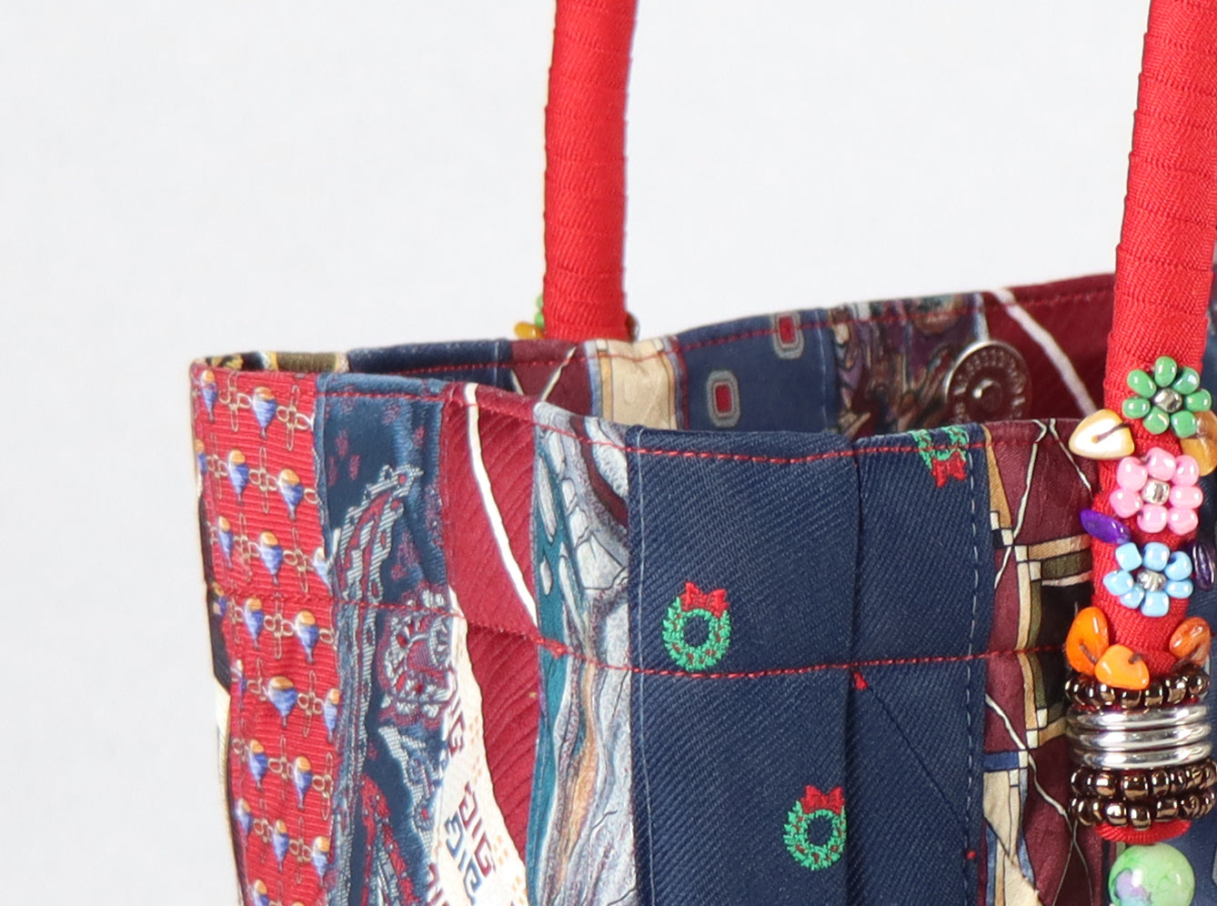 Goes in red handle, red tassel, and a range of red to denim ties for the body.