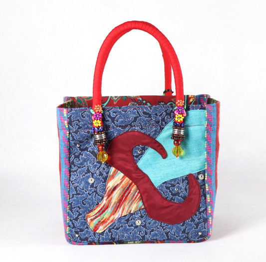 The bag comes in red handle, Aztec pattern on the side, and a red and green flower pattern on the back.