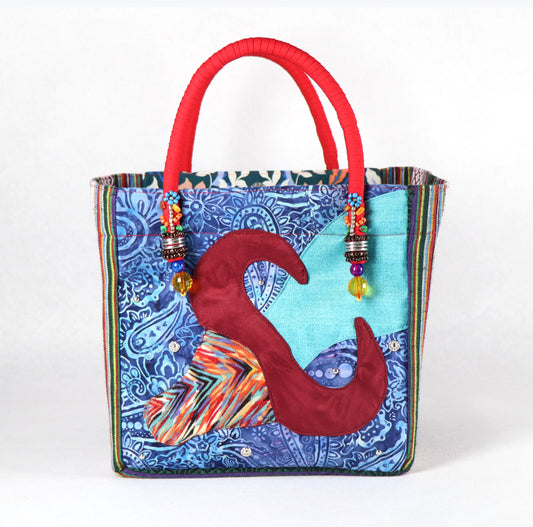 The bag comes in red handle, green Aztec pattern on the side, and a green, yellow, and blue flower pattern on the back.