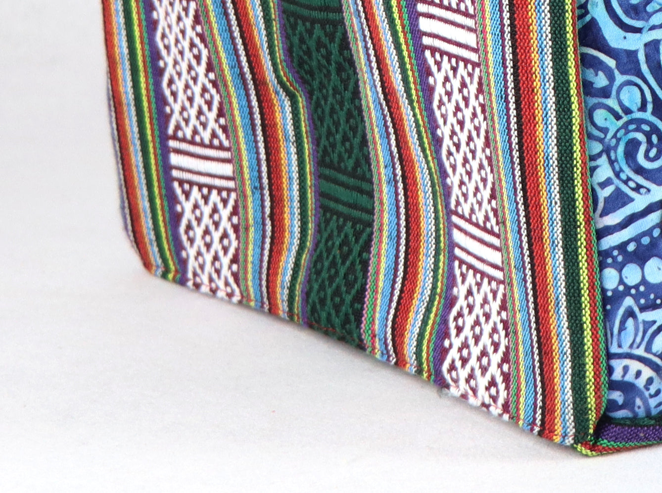 The bag comes in red handle, green Aztec pattern on the side, and a green, yellow, and blue flower pattern on the back.