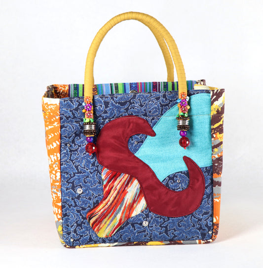 The bag comes in yellow handle, some leaves pattern on the side, and a green and purple Aztec pattern on the back.