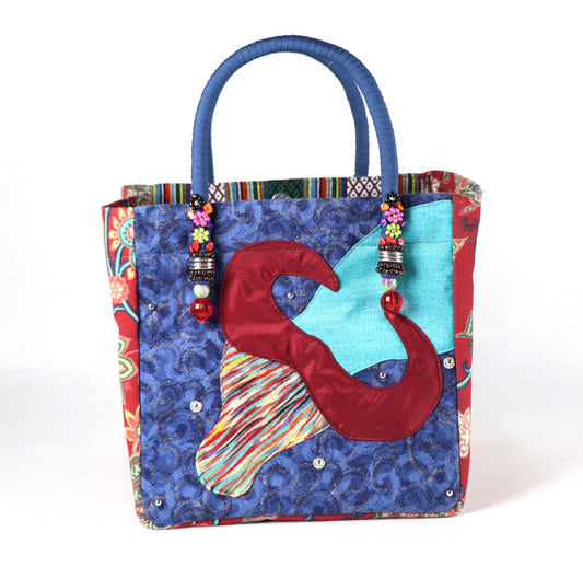 The bag comes in blue handle, red flower patterns on the side, and a green Aztec pattern on the back.