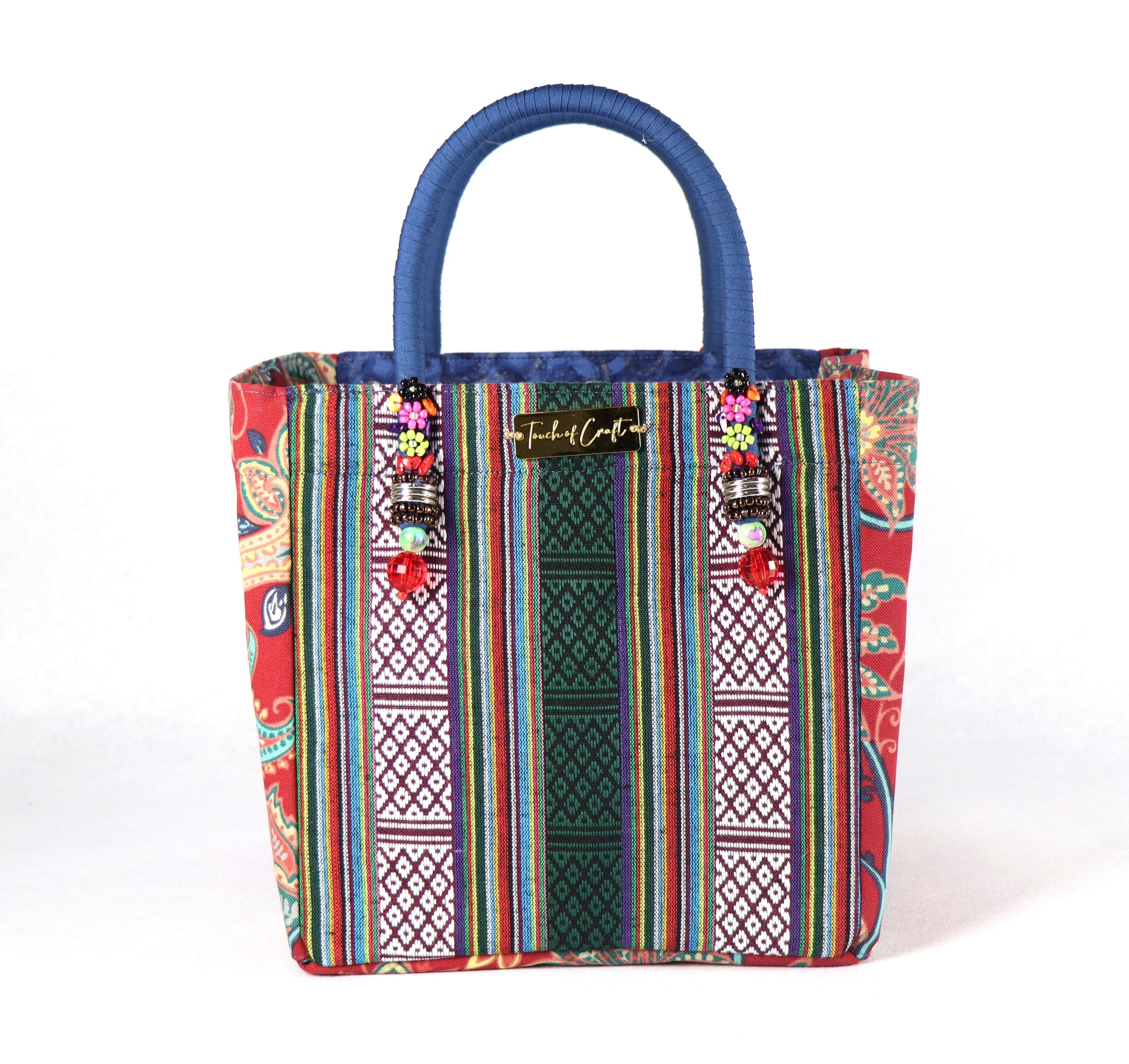 The bag comes in blue handle, red flower patterns on the side, and a green Aztec pattern on the back.