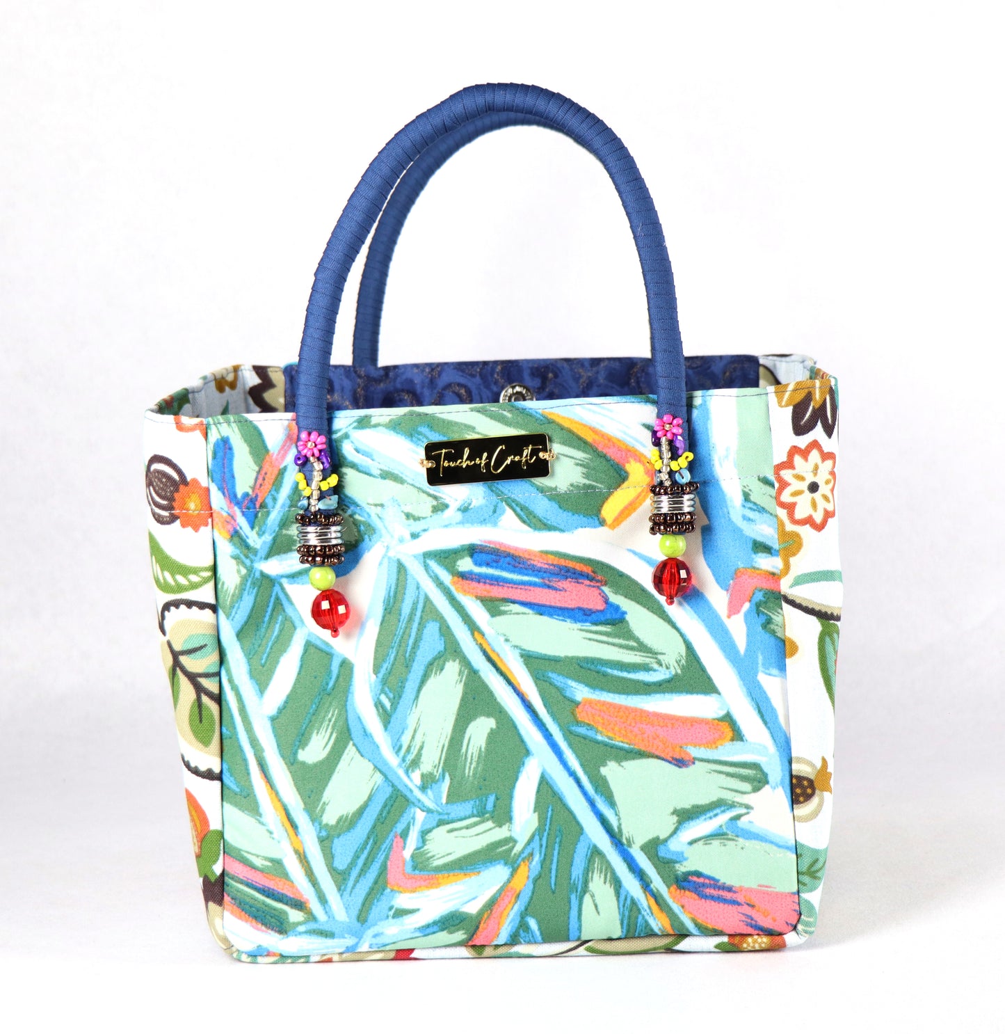 The bag comes in blue handle, yellow, orange and green flower patterns on the side, and a green leaves pattern on the back.