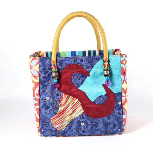 The bag comes in mustard handle, some orange-yellow patterns on the side, and a green to blue Aztec pattern on the back.