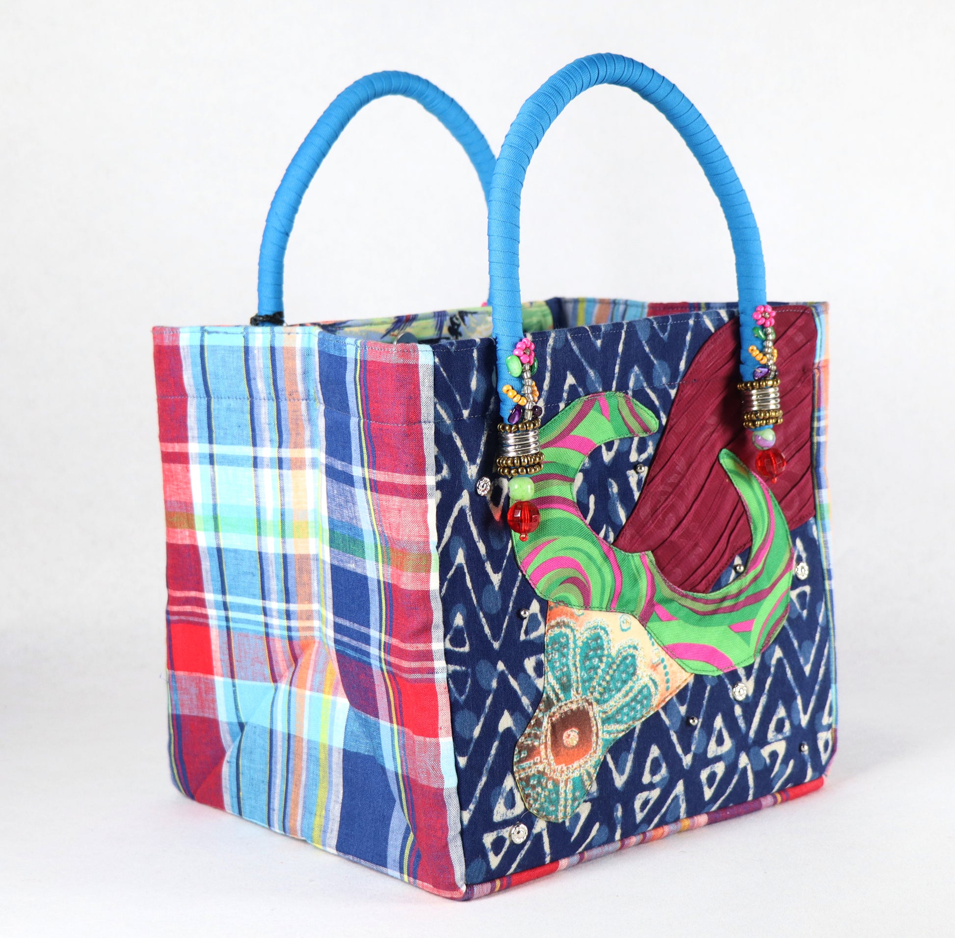 The bag comes in light blue handle, blue-red checkered on the side, and a paradise pattern on the back.